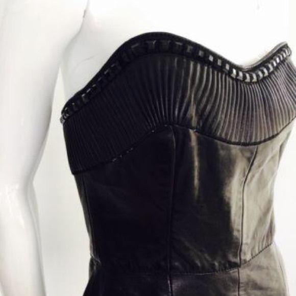 Black leather  strapless dress. 

Features a sweethart plunge cleavage. - Picture 6 of 11